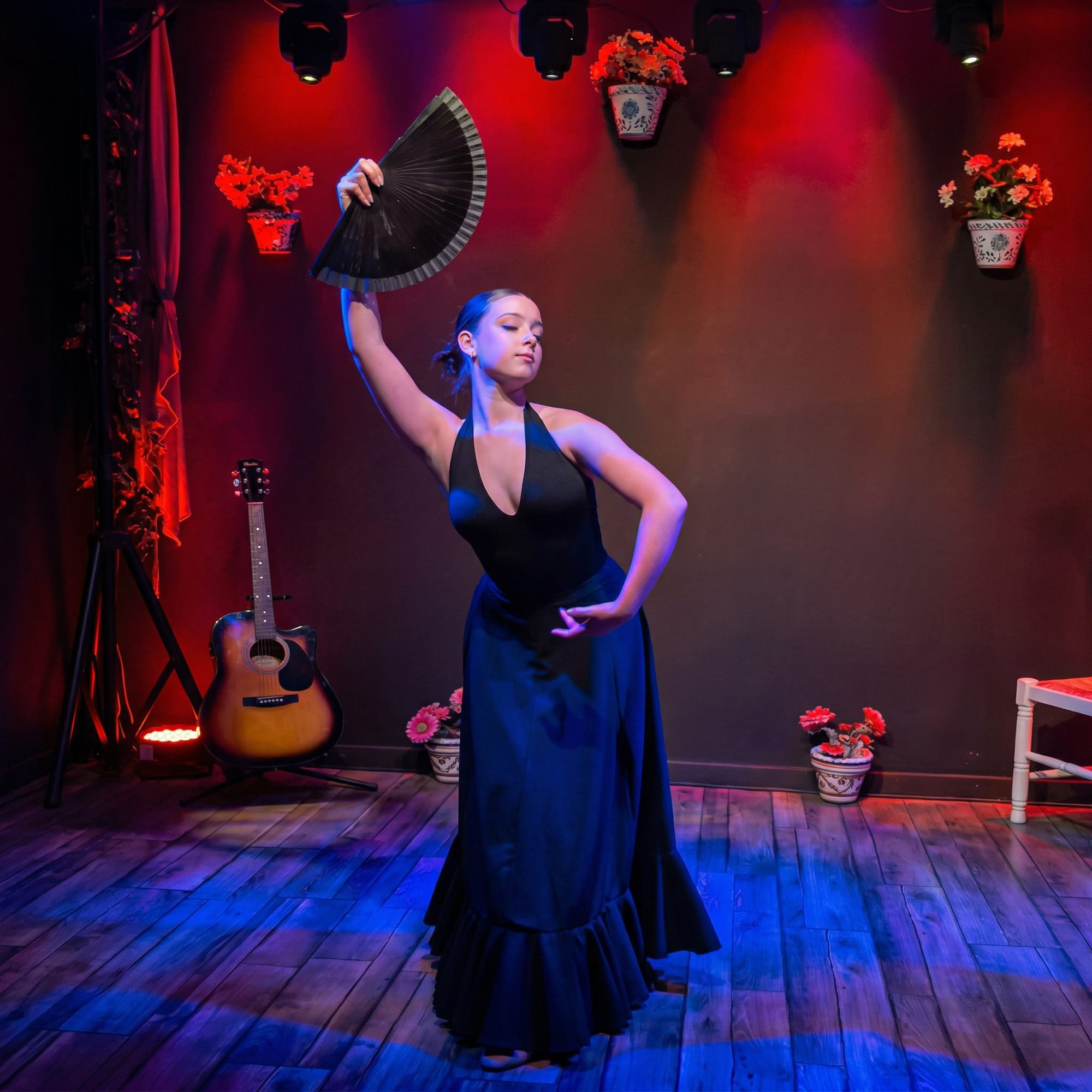 Flamenco dancer with a fan on stage